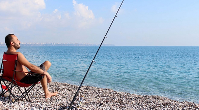 Antalya'da tatilciler güneşli havanın keyfini denize girerek çıkardı